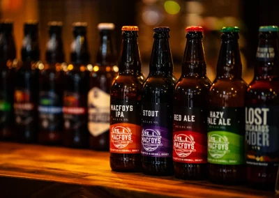 Close-up of MacFoys beer bottles chilling behind the bar.