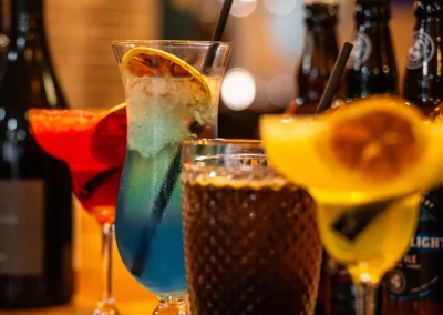 Four colourful cocktails lined up on the bar at The Murray Arms.