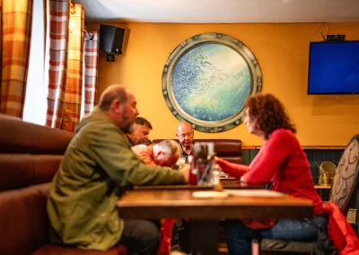 A group of diners enjoying a meal together at the table.
